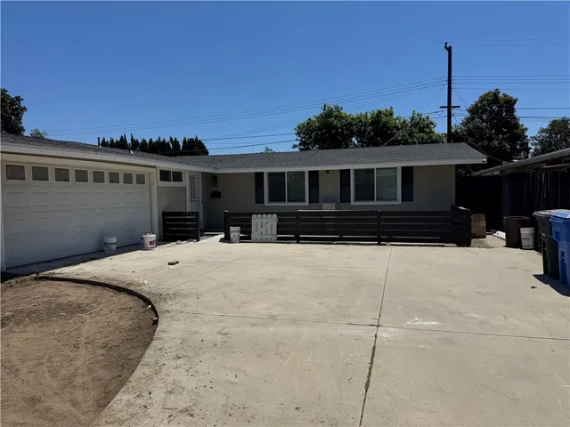 a front view of a house with a yard and a garage