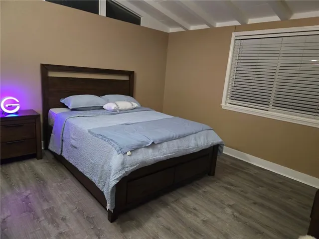 a bed sitting in a bedroom next to a window