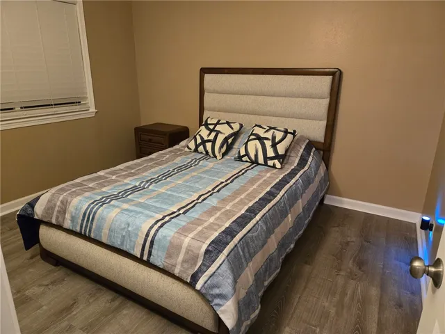a bed sitting in a bedroom next to a window
