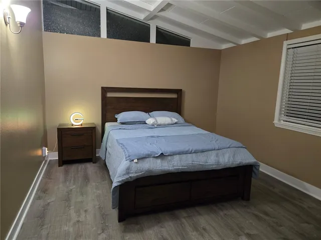 a bedroom with a bed and a night stand