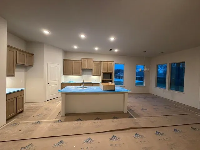 a view of kitchen with stainless steel appliances granite countertop sink and cabinets
