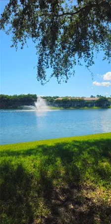 a view of a lake with houses in the background