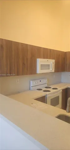 a view of kitchen and empty room