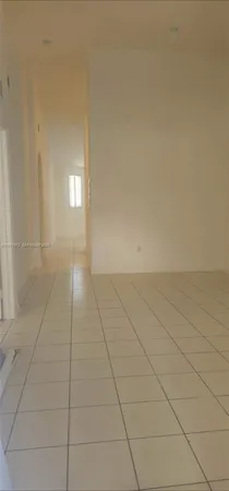 a view of an empty room and a bathroom