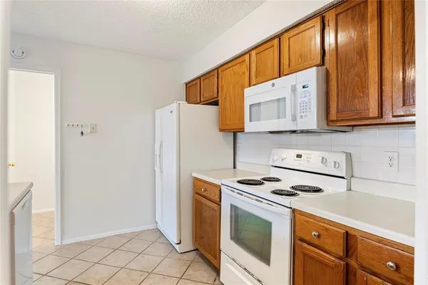 a kitchen with stainless steel appliances granite countertop a stove a refrigerator and a cabinets