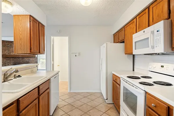 a kitchen with a sink cabinets and appliances