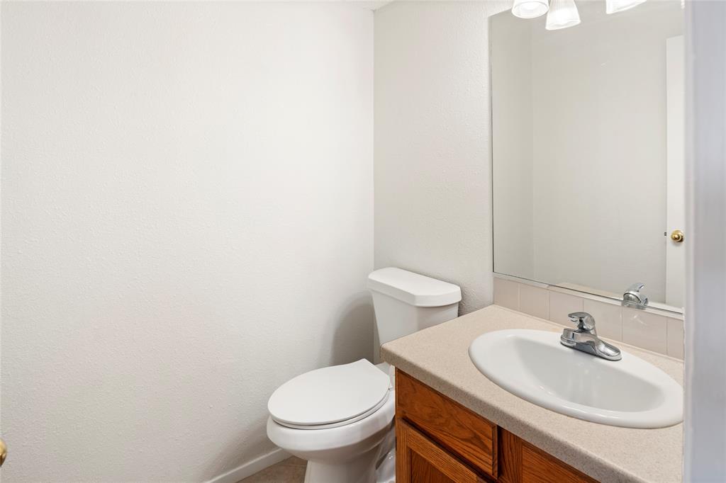 7591 Tournament Road Frisco, TX 75035 - Photo 15 of 26 a bathroom with a sink and a toilet