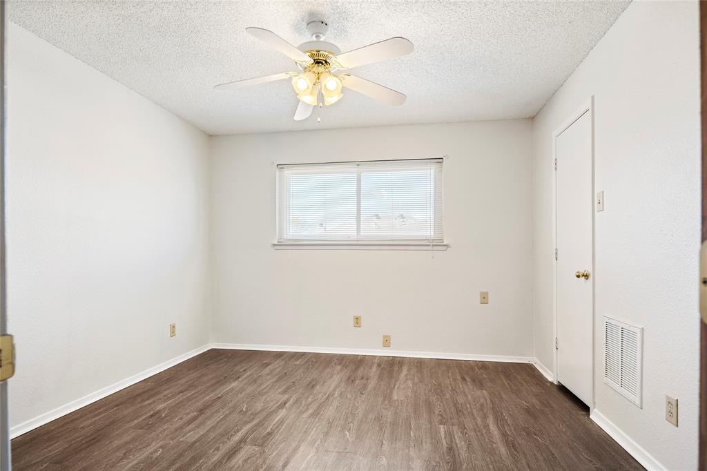 7591 Tournament Road Frisco, TX 75035 - Photo 16 of 26 an empty room with a window and wooden floor