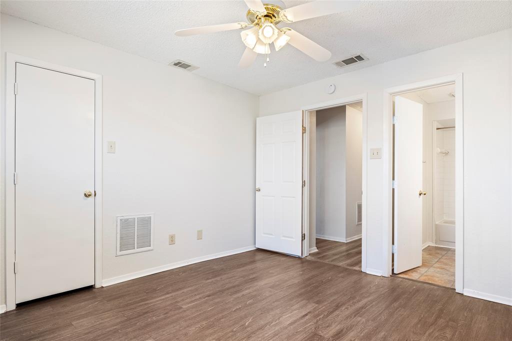 7591 Tournament Road Frisco, TX 75035 - Photo 18 of 26 an empty room with wooden floor and a ceiling fan