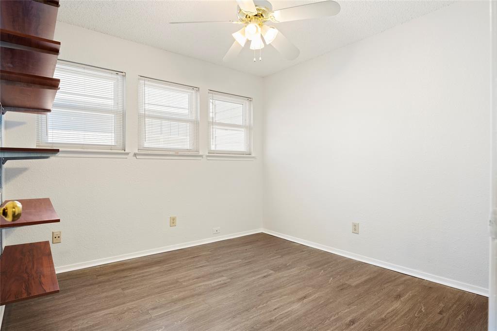 7591 Tournament Road Frisco, TX 75035 - Photo 21 of 26 an empty room with wooden floor and windows
