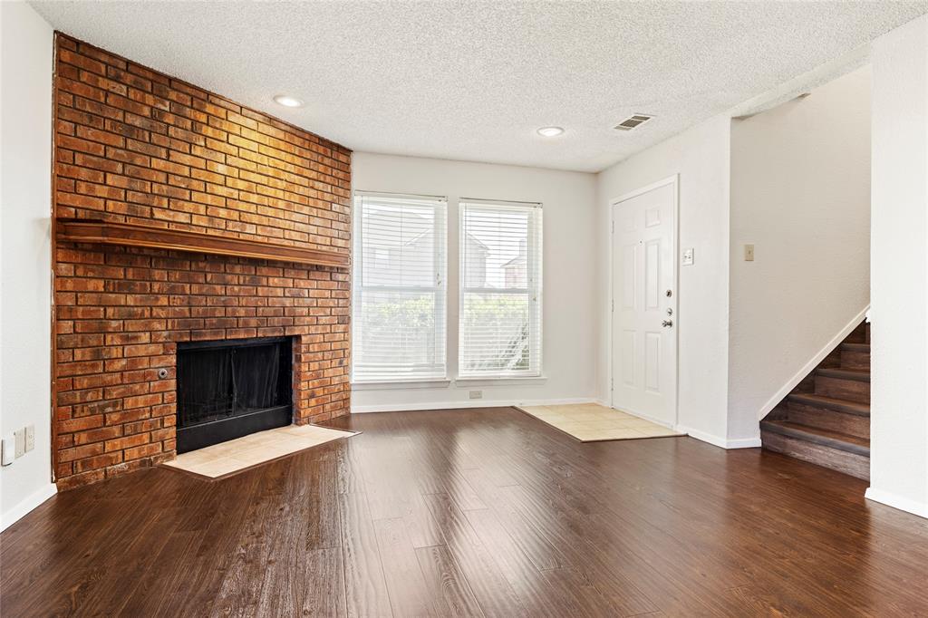 7591 Tournament Road Frisco, TX 75035 - Photo 3 of 26 a view of an empty room with wooden floor fireplace and a window