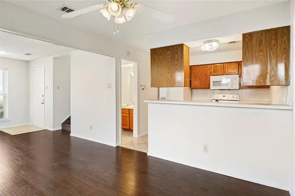 a room with wooden floor and chandelier