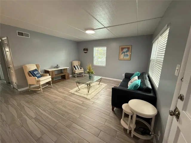 a living room with furniture and a wooden floor