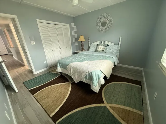a bedroom with a bed and a mirror