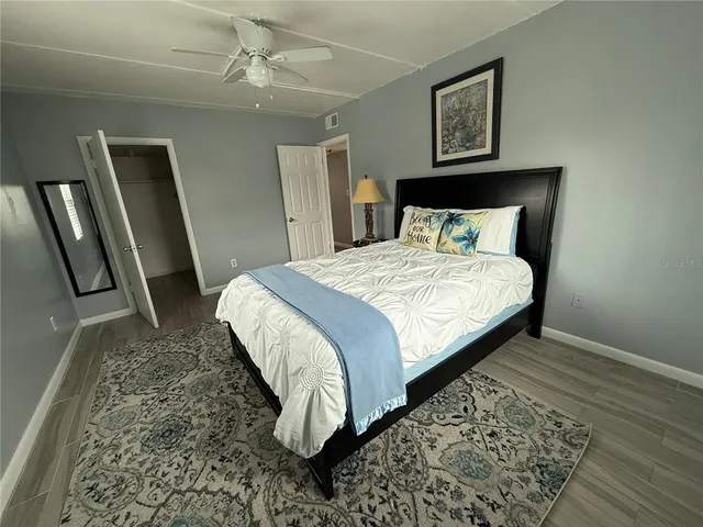 a bed sitting in a bedroom next to a window