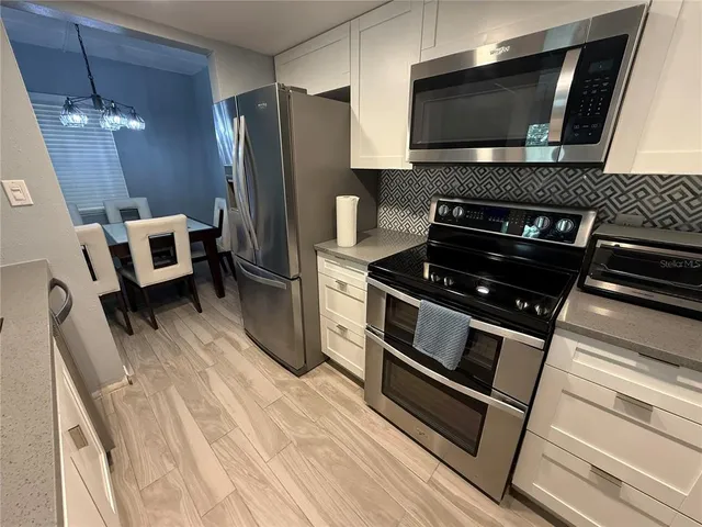 a kitchen with a stove and a microwave