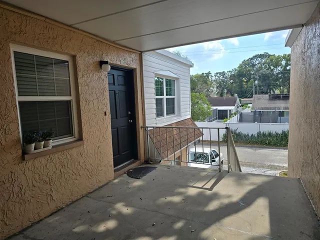 a view of a house with backyard porch and sitting area