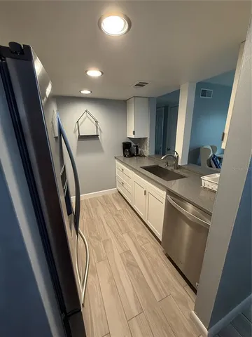 a kitchen with stainless steel appliances granite countertop a sink stove and cabinets