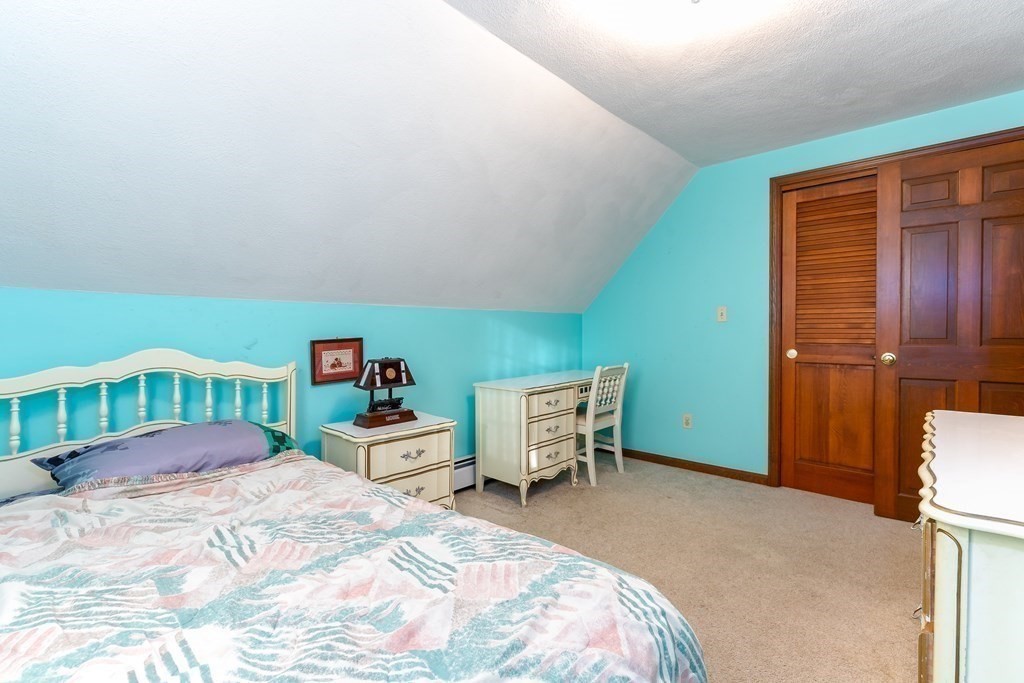 1920 Maple Street Dighton, MA 02764 - Photo 25 of 42 a bedroom with a bed and a desk in it
