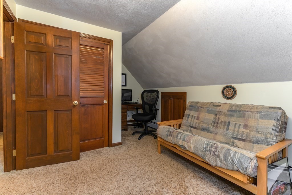 1920 Maple Street Dighton, MA 02764 - Photo 27 of 42 a bedroom with a bed and a table