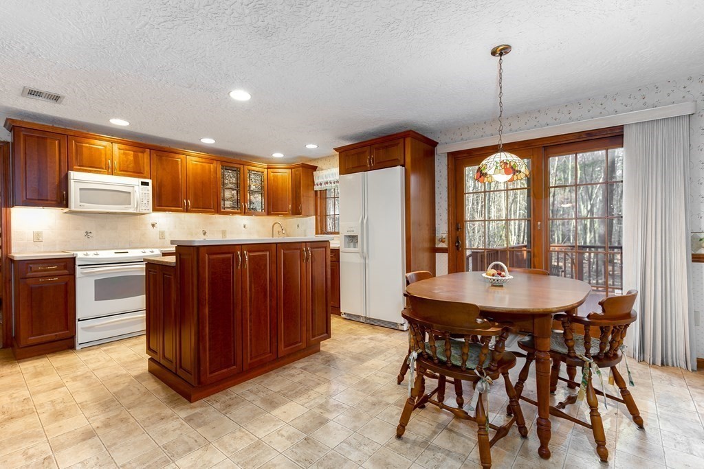1920 Maple Street Dighton, MA 02764 - Photo 8 of 42 a kitchen with a table chairs sink and cabinets