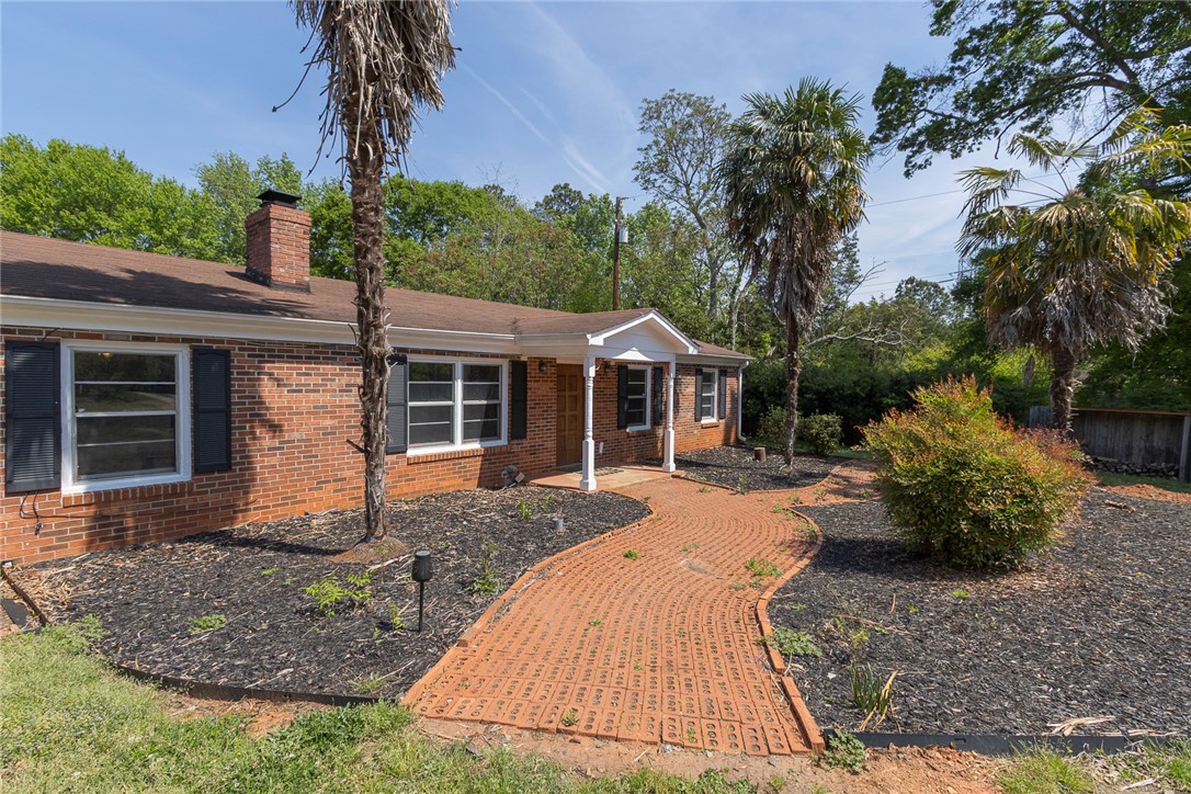 820 Travis Road Anderson, SC 29626 - Photo 8 of 46 This brick residence offers a classic facade with a welcoming pathway to the entrance.