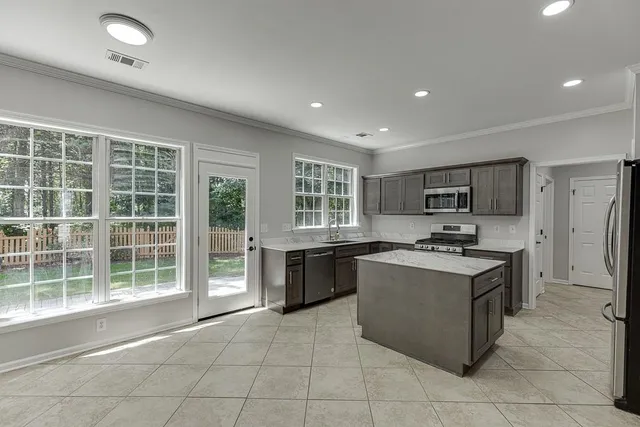 a utility room with sink dryer and washer