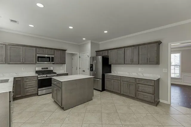 a bathroom with a sink a large mirror and a window