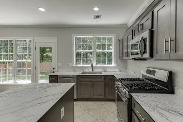 an empty room with windows and ceiling fan