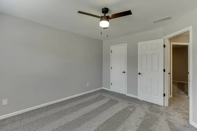 a view of a backyard with large trees
