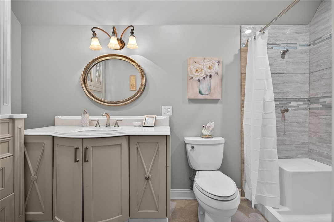 206 James Hare Road Anderson, SC 29626 - Photo 26 of 37 A well-appointed bathroom features a practical vanity with an elegant mirror and a conveniently designed shower with a built-in bench.