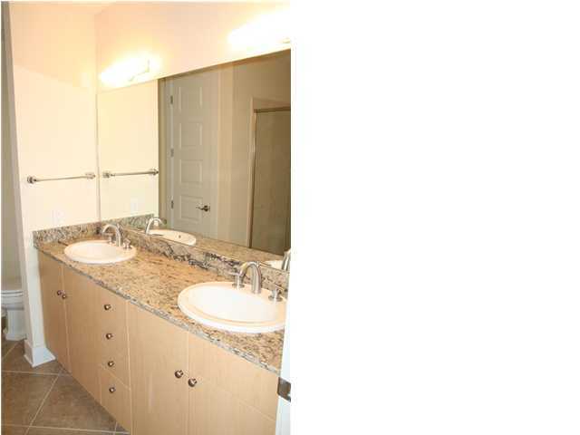 211 Durango Road, Unit 415 Destin, FL 32541 - Photo 6 of 12 a bathroom with a sink and a mirror