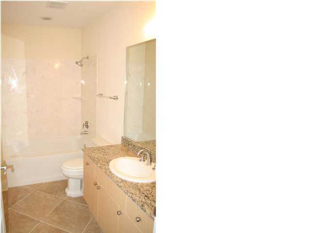 211 Durango Road, Unit 415 Destin, FL 32541 - Photo 8 of 12 a bathroom with a granite countertop sink a toilet and a mirror