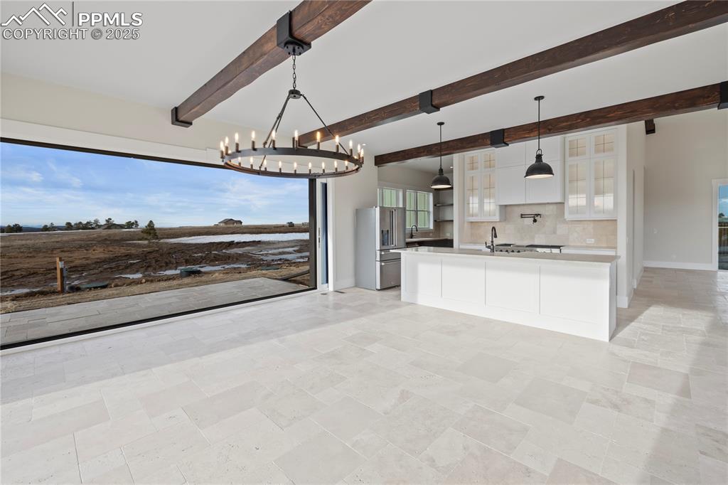 16864 Horizon Ridge Trail Colorado Springs, CO 80908 - Photo 19 of 47 a large white kitchen with a stove and a refrigerator