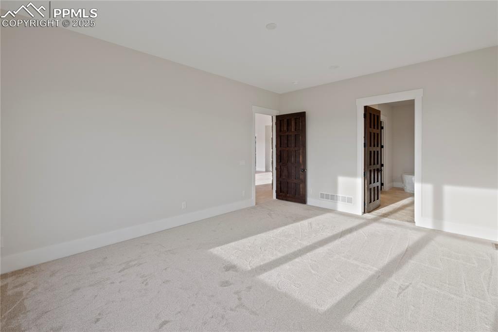 16864 Horizon Ridge Trail Colorado Springs, CO 80908 - Photo 35 of 47 Unfurnished bedroom with light carpet, baseboards, and visible vents