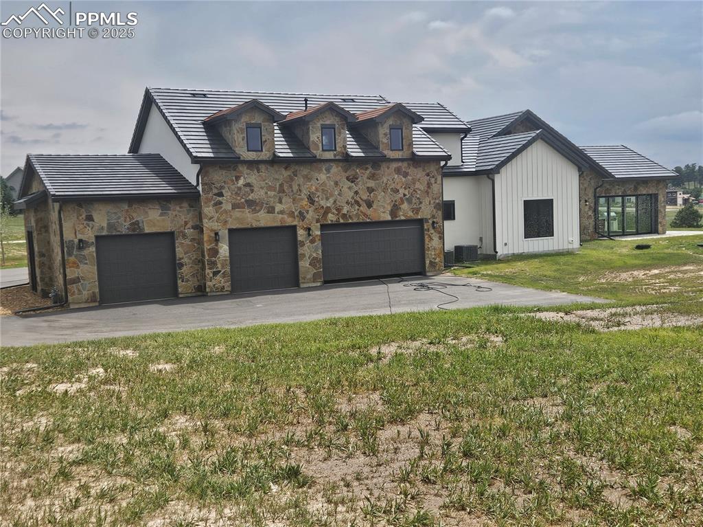 16864 Horizon Ridge Trail Colorado Springs, CO 80908 - Photo 6 of 47 a view of a house with a yard and garage