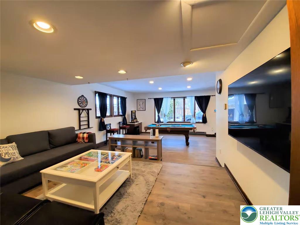 1271 Kilmer Road Tobyhanna, PA 18466 - Photo 26 of 45 a living room with furniture a wooden floor and kitchen view