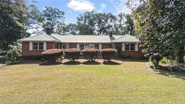a front view of a house with yard and porch