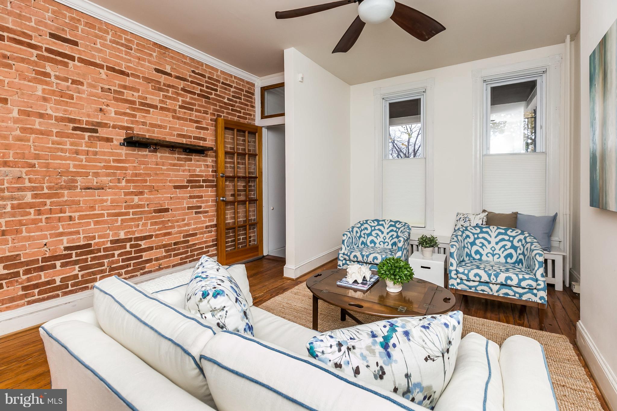 3236 Keswick Road Baltimore, MD 21211 - Photo 5 of 37 Light & Bright Living Room with Exposed Brick Wall