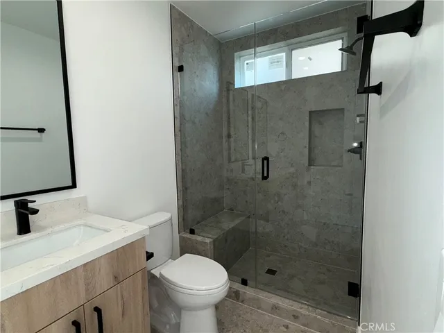 a bathroom with a sink toilet and shower