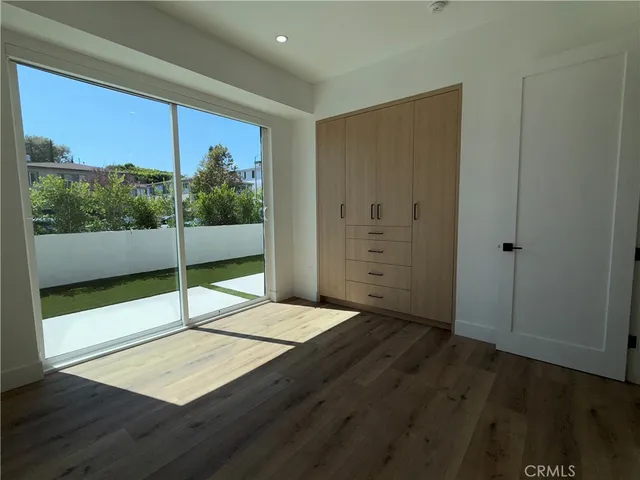 a view of a room with wooden floor and window