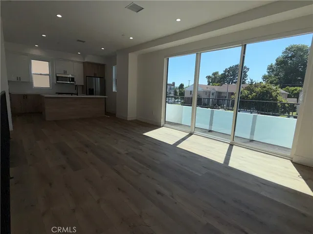 a view of a kitchen with a sink wooden floor and a kitchen
