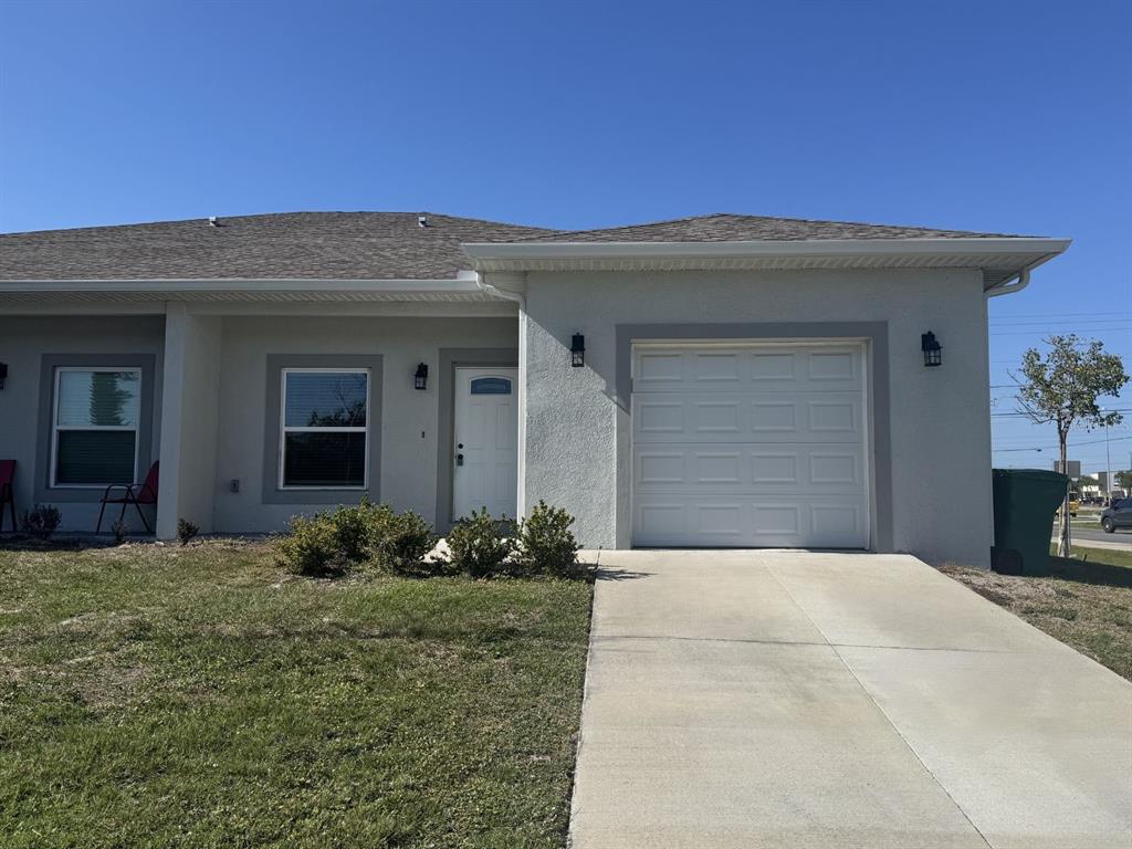 10524 Pendleton Avenue Englewood, FL 34224 - Photo 1 of 12 a front view of a house with a yard