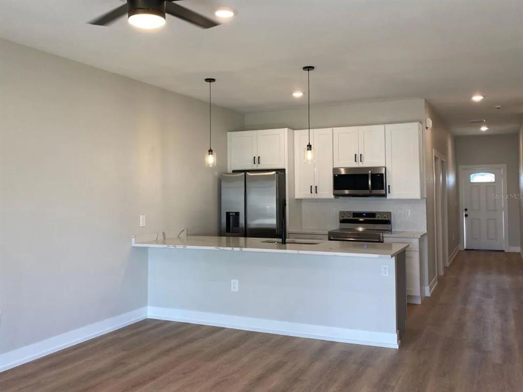 10524 Pendleton Avenue Englewood, FL 34224 - Photo 11 of 12 a kitchen with stainless steel appliances a stove a sink and a refrigerator