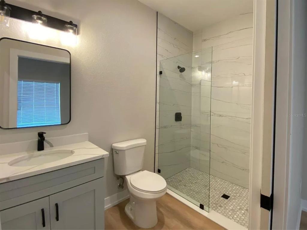10524 Pendleton Avenue Englewood, FL 34224 - Photo 5 of 12 a bathroom with a sink toilet and shower