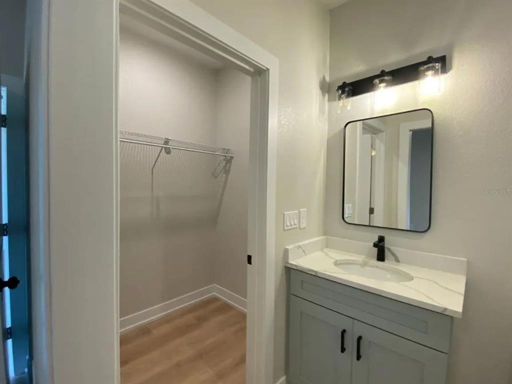 10524 Pendleton Avenue Englewood, FL 34224 - Photo 6 of 12 a bathroom with a sink and mirror with toilet