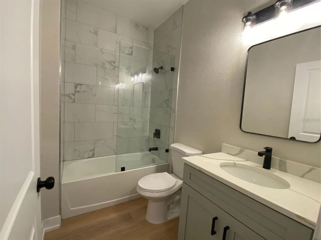 10524 Pendleton Avenue Englewood, FL 34224 - Photo 8 of 12 a bathroom with a sink toilet a shower and a mirror