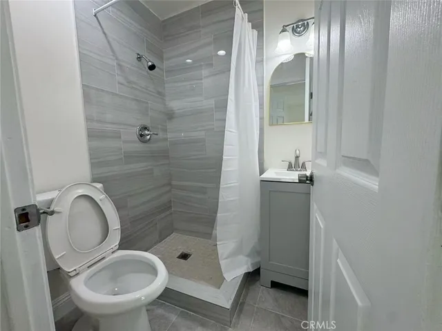 a bathroom with a granite countertop toilet sink and shower