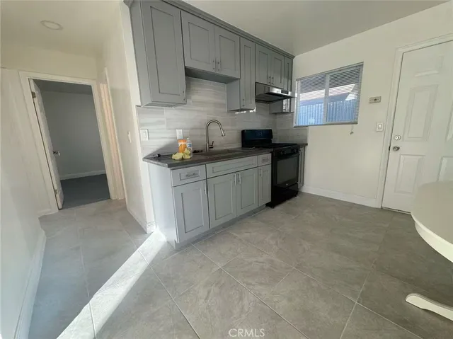a kitchen with stainless steel appliances a sink stove and refrigerator