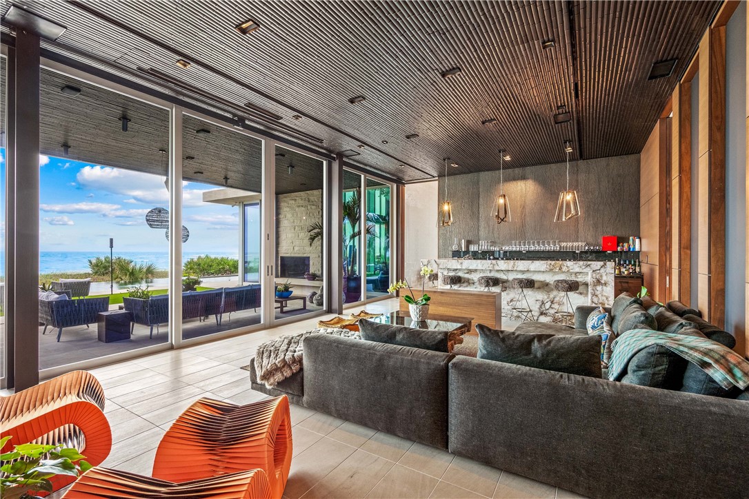 3700 Ocean Drive Vero Beach, FL 32963 - Photo 14 of 36 a living room with furniture kitchen view and a large window